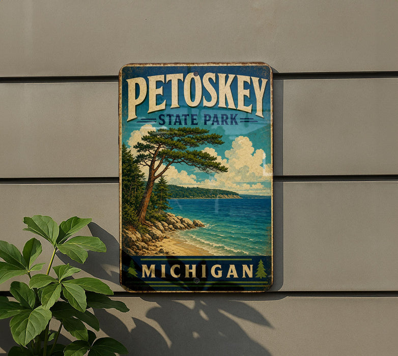 A vintage-style sign for Petoskey State Park in Michigan, featuring a scenic landscape with a pine tree, beach, and ocean.