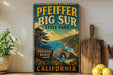 A vintage-style sign for Pfeiffer Big Sur State Park, featuring a scenic coastal landscape with mountains, water, and a beach sign.