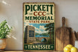 A vintage-style sign for PickettCC Memorial State Park in Tennessee, featuring a scenic illustration of the park and a bridge.