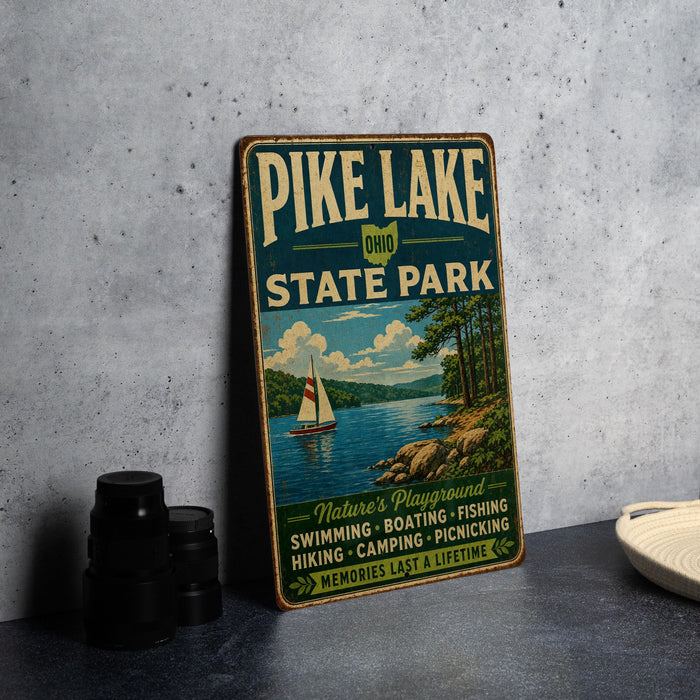 A vintage-style metal sign for Pike Lake State Park, featuring a scenic illustration of a lake, sailboat, and mountains.
