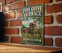 A vintage-style sign for Pine Grove Furnace State Park in Pennsylvania, featuring a brick wall and a wooden table in the foreground.