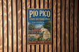 A vintage-style metal sign for Pio Pico State Historic Park in California, featuring an illustration of a historic building surrounded by palm trees.