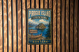 A vintage-style metal sign for Pirogue Island State Park in Montana, featuring a scenic illustration of the island and its surrounding landscape.