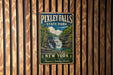 A vintage-style metal sign for Pixtley Falls State Park in New York, featuring a waterfall and forest landscape.