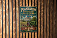 A vintage metal sign for Plantation Agriculture Museum in Arkansas, featuring an illustration of a house, a windmill, and a tractor.