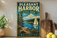 A vintage-style sign for "Pleasant Harbor State Park" in Washington, featuring a scenic image of a sailboat on a lake surrounded by pine trees and mountains.