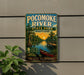 A vintage-style metal sign for Pocomoke River State Park in Maryland, featuring a scenic illustration of the river, a boat, and a sunset.