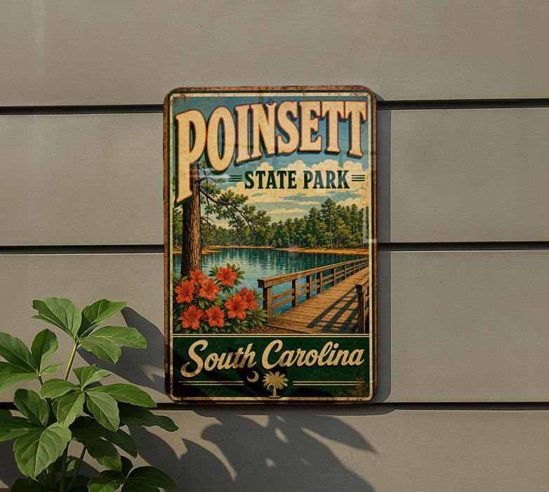 A vintage-style metal sign for Poinsett State Park in South Carolina, featuring a scenic image of a wooden bridge and a lake surrounded by trees.