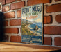 a vintage-style sign for Point Mugu State Park, California, mounted on a brick wall.