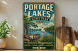 A vintage-style sign for Portage Lakes State Park in Ohio, featuring a scenic illustration of a lake, a wooden dock, and a sailboat.