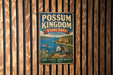 A vintage metal sign for POSSUM KINGDOM STATE PARK, TEXAS, featuring an illustration of a lake, cliffs, and wildlife.