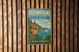A vintage metal sign for Potawatomi State Park in Wisconsin, featuring a scenic landscape with a sailboat on the water.