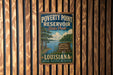A vintage-style metal sign for Poverty Point Reservoir State Park in Louisiana, featuring a scenic landscape with a river and trees.