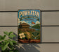A vintage-style metal sign for Powhatan Historic State Park in Arkansas, featuring an illustration of a wooden cabin and a river.