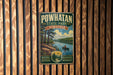 A vintage-style metal sign for Powhatan State Park in Virginia, featuring a scenic landscape with a river, trees, and a person in a canoe.