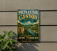 A vintage-style metal sign for Preparation Canyon State Park, featuring a scenic landscape with a river and cliffs, mounted on a wall.