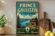 A vintage-style sign for Prince Gallitzin State Park, featuring a scenic landscape with a cabin and mountains in the background.