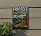 A vintage-style metal sign for the Prospect State Scenic Viewpoint in Oregon, featuring a mountain landscape and a stone structure.