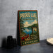 A vintage-style metal sign for the Proud Lake Recreation Area in Michigan, featuring a scenic image of a lake, canoe, and surrounding forest.