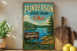 A vintage-style sign for Punderton State Park in Ohio, featuring a scenic lake and mountains, with a wooden sign that says "Find your adventure!" and a message about the park's scenic beauty and outdoor fun.