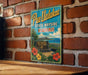 A vintage-style metal sign with the text "Pau Ualaikaa State Wayside Hawaii" is displayed on a brick wall.