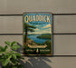 A vintage-style sign for Quaddick State Park, featuring a scenic landscape with a lake and mountains in the background.