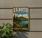 A vintage-style metal sign for R.B. Winter State Park in Pennsylvania, featuring a scenic landscape with a lake, mountains, and a sailboat.
