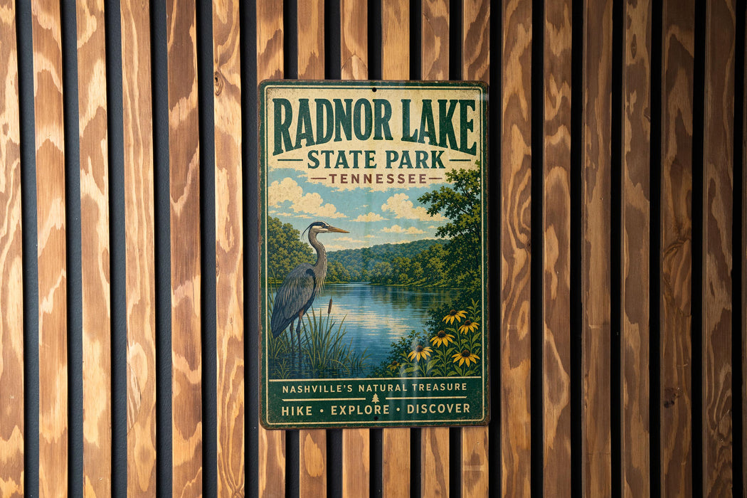 A vintage metal sign for Radnor Lake State Park in Tennessee, featuring a scenic illustration of a lake, a heron, and a forest landscape.