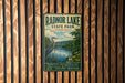 A vintage metal sign for Radnor Lake State Park in Tennessee, featuring a scenic illustration of a lake, a heron, and a forest landscape.