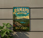 A vintage-style metal sign for Ramapo Mountain State Forest in New Jersey, featuring a scenic landscape with mountains, trees, and a lake.