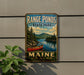 A vintage-style metal sign for Range Ponds State Park in Maine, featuring a scenic image of a lake with a red canoe and pine trees.