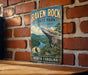 A vintage-style metal sign for Raven Rock State Park in North Carolina, featuring a scenic mountain landscape with a river and a cliff.