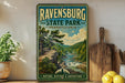 a vintage-style sign for Ravenswood State Park in Pennsylvania, with a scenic illustration of a forest and a river.