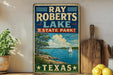 A vintage-style sign for Ray Roberts Lake, a state park in Texas, featuring a scenic illustration of a lake, trees, and a sailboat.