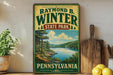 A vintage-style sign for Raymond Winter State Park in Pennsylvania, featuring a scenic landscape with a lake and mountains.