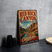 A vintage-style metal sign for Red Rock Canyon State Park in Oklahoma, featuring a scenic illustration of the canyon landscape.