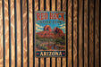 A vintage metal sign for Red Rock State Park in Arizona, featuring a scenic illustration of the park's landscape.