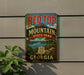 A vintage metal sign for Red Top Mountain State Park in Georgia, featuring a scenic landscape with mountains, water, and a pine tree.