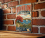 A vintage-style metal sign for the Red Willow State Recreation Area in Nebraska, featuring a scenic landscape with a sailboat on a lake.