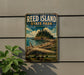 A vintage-style metal sign for Reed Island State Park in Washington, featuring a scenic landscape with a mountain, trees, and a body of water.