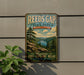 A vintage-style metal sign for Reeds Gap State Park in Pennsylvania, featuring a scenic mountain landscape with pine trees and a lake.