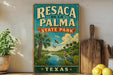 A vintage-style sign for Resaca de la Palma State Park in Texas, featuring a tropical landscape with palm trees, a river, and birds.