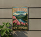 A vintage-style sign for Rhododendron State Park in New Hampshire, featuring a scenic landscape with mountains, trees, and pink flowers.