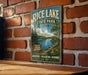 A vintage-style metal sign for Rice Lake State Park in Iowa, featuring a scenic landscape with a lake, trees, and mountains.