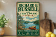 A vintage-style sign for Richard B. Russell State Park in Georgia, featuring a scenic illustration of a lake and mountains.