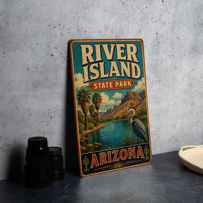 A vintage-style sign for River Island State Park in Arizona, featuring a scenic landscape with palm trees, mountains, and a bird.