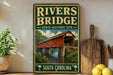 A vintage-style sign for the "Rivers Bridge" in South Carolina, featuring an illustration of a covered bridge over a river.