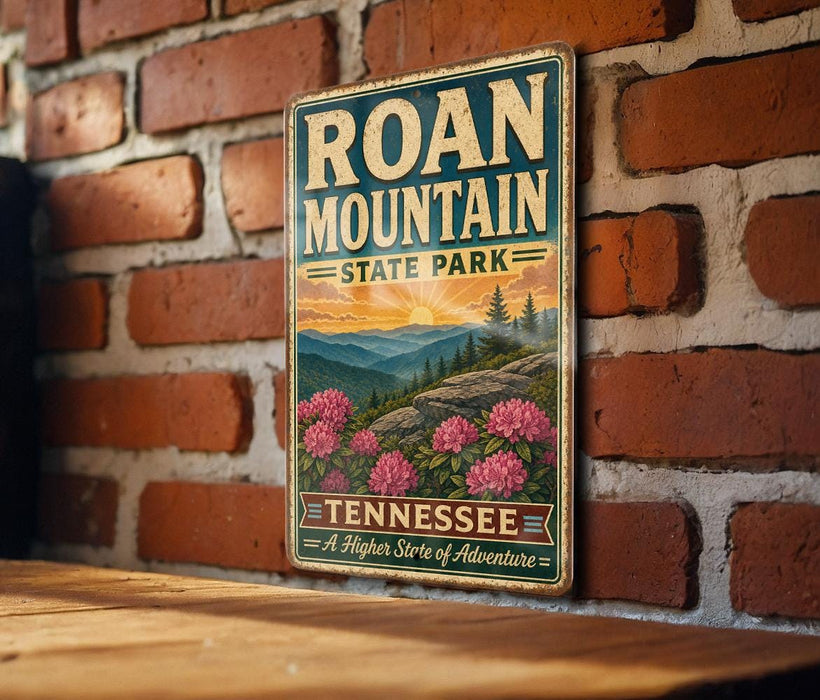 A vintage-style metal sign for Roan Mountain State Park in Tennessee, featuring a scenic landscape with mountains, pine trees, and pink flowers.