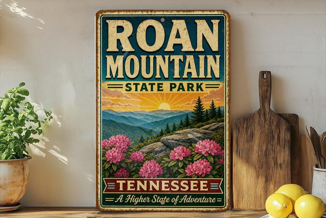 A vintage-style metal sign for Roan Mountain State Park in Tennessee, featuring a scenic landscape with mountains, pine trees, and pink flowers.