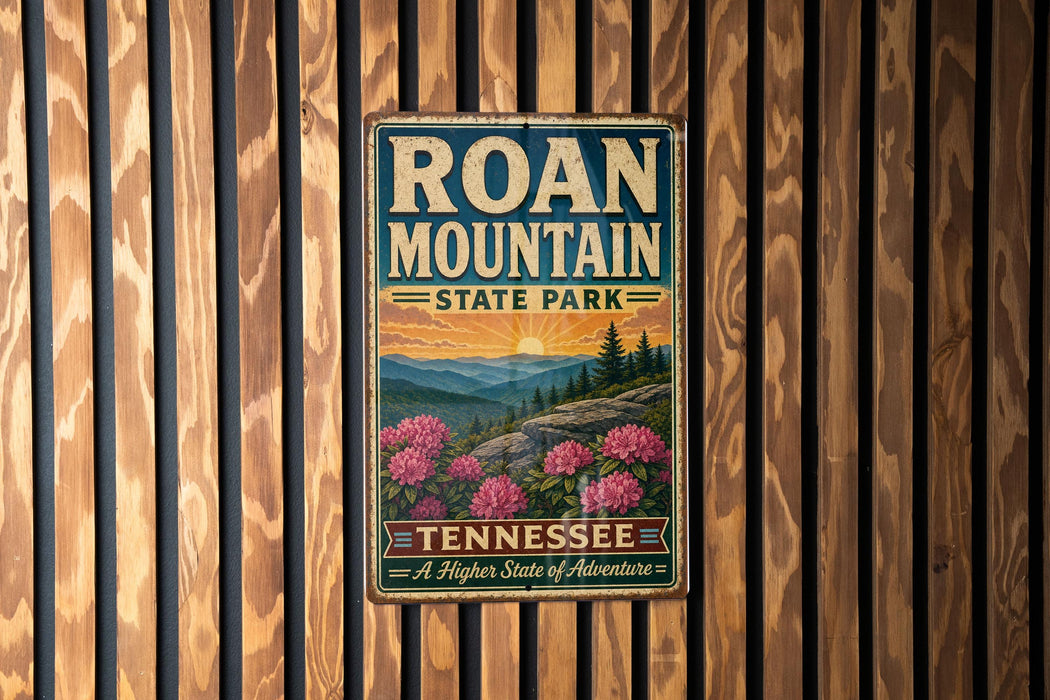 A vintage-style metal sign for Roan Mountain State Park in Tennessee, featuring a scenic landscape with mountains, pine trees, and pink flowers.
